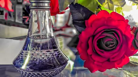 Artificial rose and parfume wallpaper