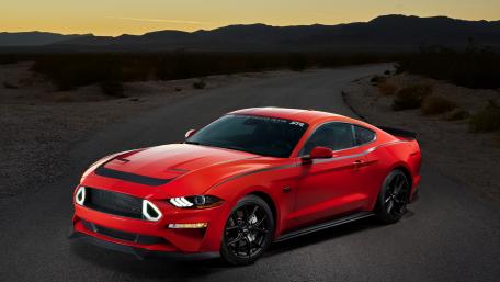 Sleek Red Ford Mustang on Open Road wallpaper