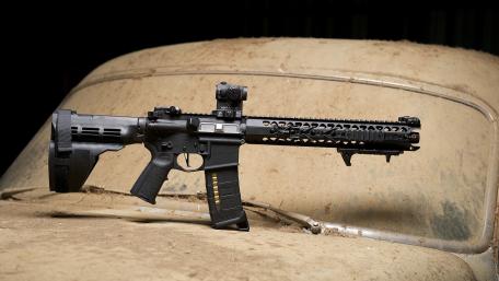 Assault Rifle Display Against Vintage Car wallpaper