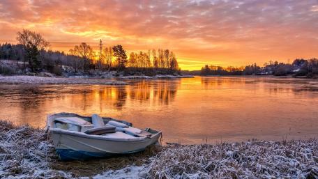 Winter Sunset Over Tranquil Lake with Boat wallpaper