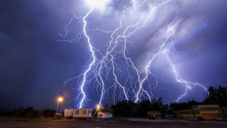 Evening Storm Illuminated by Lightning Strikes wallpaper