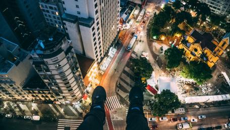 Man sitting on high rise building wallpaper