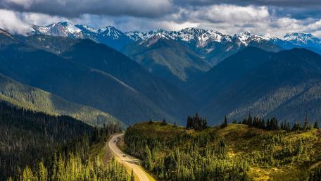 Majestic Mountain Pass in Lush Valley wallpaper