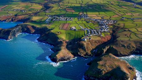 Serene Aerial View of Coastal Bay and Lush Fields wallpaper