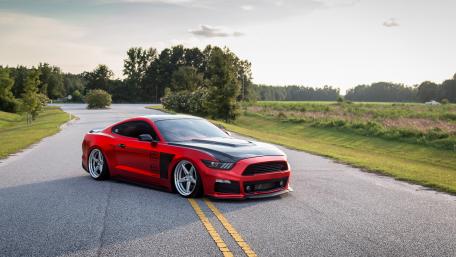 Sleek Red Muscle Car on an Open Road wallpaper