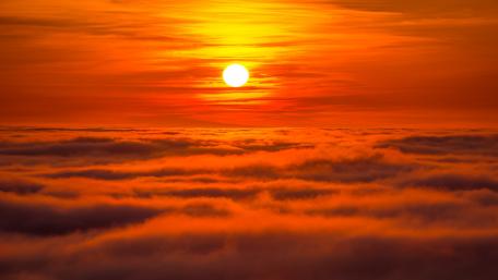 Fiery Sunset Over Clouds wallpaper