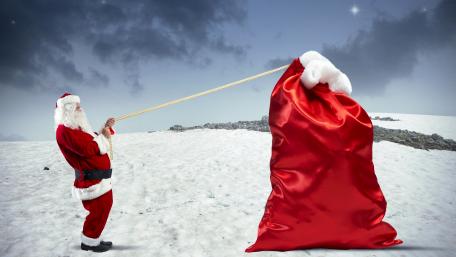 Santa Claus with a huge red sack wallpaper