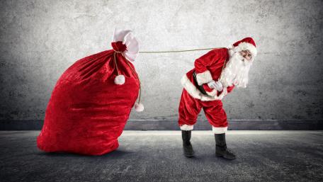 Santa Claus pulls his red sack wallpaper