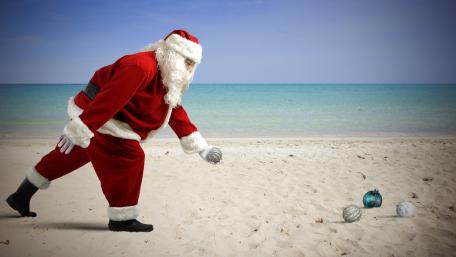 Santa playing on the sandy beach wallpaper