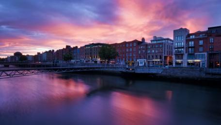 Cityscape at Dawn with Purple Sky and Reflection wallpaper