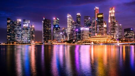 City Lights Reflecting on Calm Waters wallpaper