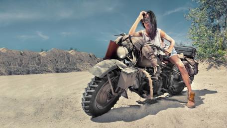 Sexy biker woman on the desert wallpaper