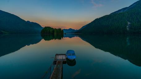 Boat at the pier on a calm lake wallpaper