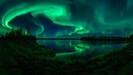 Aurora Borealis Dance Over Tranquil Waters wallpaper