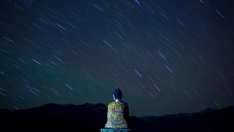 Star trails over Buddha wallpaper