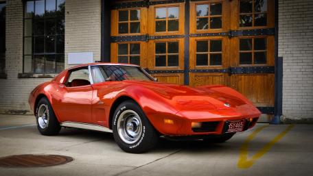 Classic Red Muscle Car in Urban Setting wallpaper