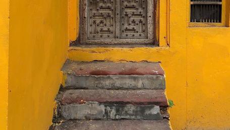 Vivid Yellow Entrance with Stairs and Doorway wallpaper