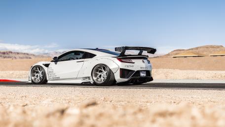 Sleek Dream Car in Stunning Desert Setting wallpaper