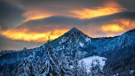 Snowy Peaks and Fiery Skies: A Winter's Embrace wallpaper