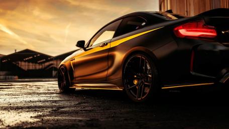 Sleek Black Car at Sunset Glow wallpaper