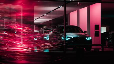 Vibrant Night Lights on a Red Car Scene wallpaper