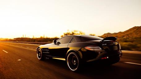 Sleek Black Supercar in Motion wallpaper