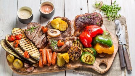 Sizzling Pork Steak and Colorful Vegetables Feast wallpaper