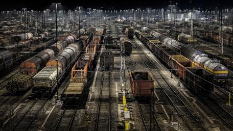 Nighttime Rail Yard Illuminated by Artificial Light wallpaper