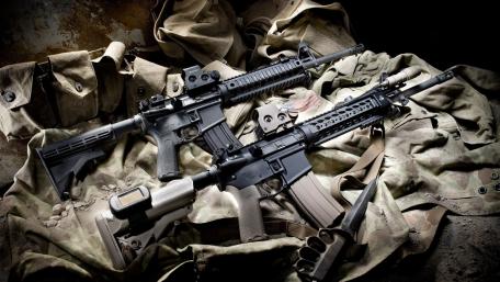 Two Tactical Assault Rifles on Camouflage Fabric wallpaper