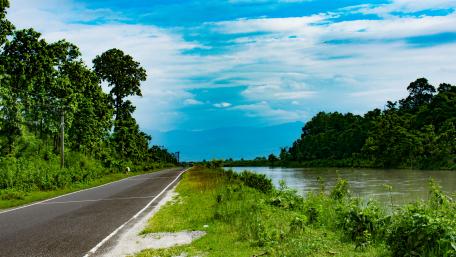 Tranquil River and Serene Roadway Scene wallpaper