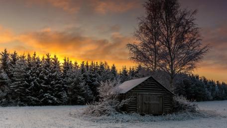 Charming Winter Cabin in Serene Landscape wallpaper