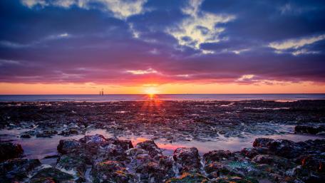 Sunset Over Rocky Coastline wallpaper