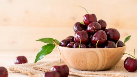 Fresh cherry in wood bowl wallpaper