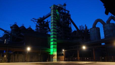 Industrial Nightscape with Green Glow in 5K Resolution wallpaper