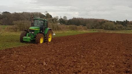 Green Tractor Plowing Serenity wallpaper