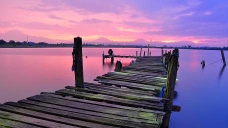 Serene Evening at the Pier Reflected in Pink Skies wallpaper