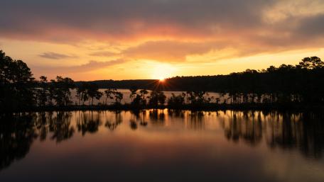 The sun rising over Jordan Lake wallpaper