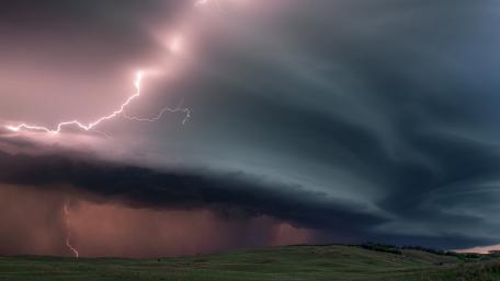 Pink lightning strikes over the field wallpaper
