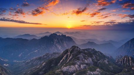 Sunrise Over Rugged Mountain Peaks wallpaper