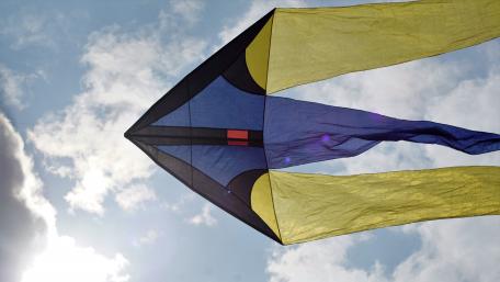 Colorful Kite Soaring Under a Blue Sky wallpaper