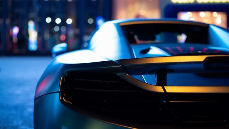 Sleek Supercar Under Bokeh Lights wallpaper