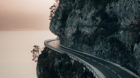 Dangerous road next to the rock wall wallpaper