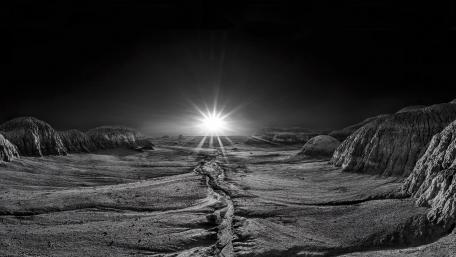 Celestial Dawn on a Monochrome Planetary Landscape wallpaper