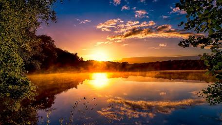 Golden Sunset Reflections Over Tranquil Lake wallpaper