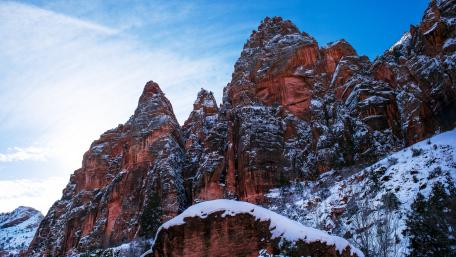Majestic Snow-Capped Peaks Under Bright Blue Sky wallpaper