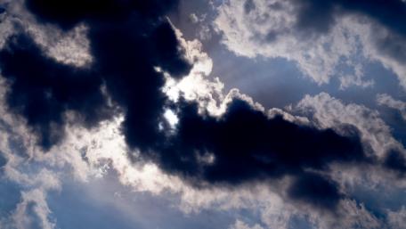 Dramatic Sky with Dark Clouds and Sunlight Shining Through wallpaper