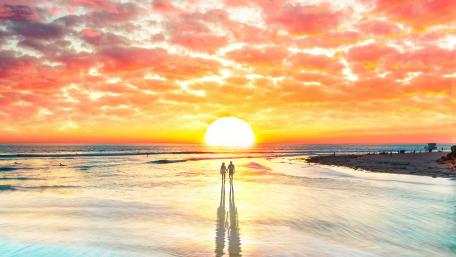 Loving Couple Watching The Sunset wallpaper