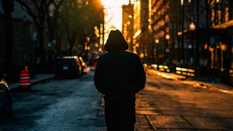 Hooded man from behind wallpaper