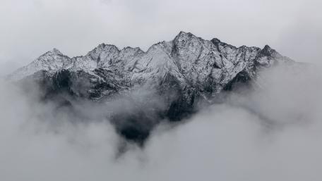 Snowy mountain in the clouds wallpaper