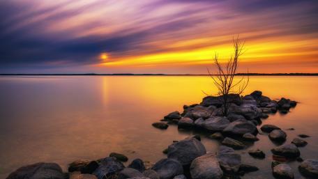 Tranquil Sunset Over Madison Lakeside Rock Formation wallpaper